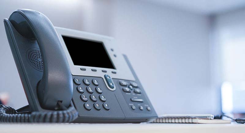 Telephone on a desk.