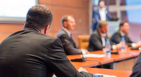 Various people at a meeting in a boardroom.