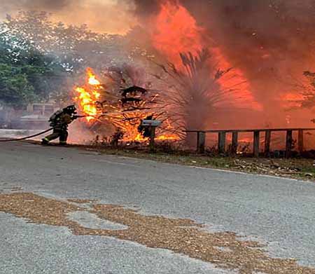 Firefighter putting out brush fire