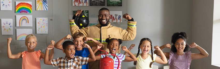 Teacher and students flexing biceps.