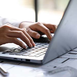 Woman typing on lap top