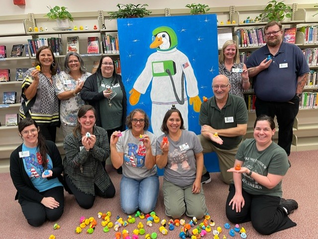 Library staff with the Astroduck mascot and rubber adventure ducks.