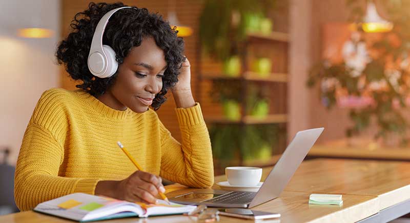 Woman With Headphones On Laptop Woman With Headphones On Laptop