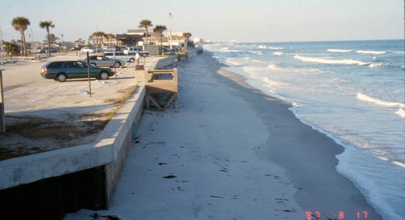 Parking lot of the Officer's club. The shoreline appears to be within 10 yard of the sea wall.