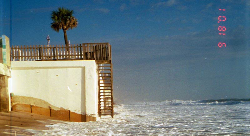 The shoreline has encrouched the side of a condo.