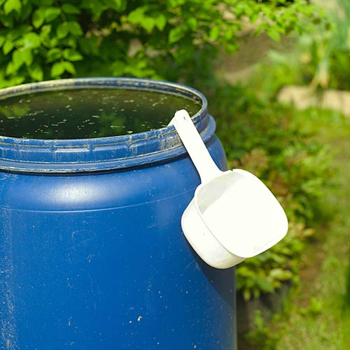 Rain barrel with scoop.