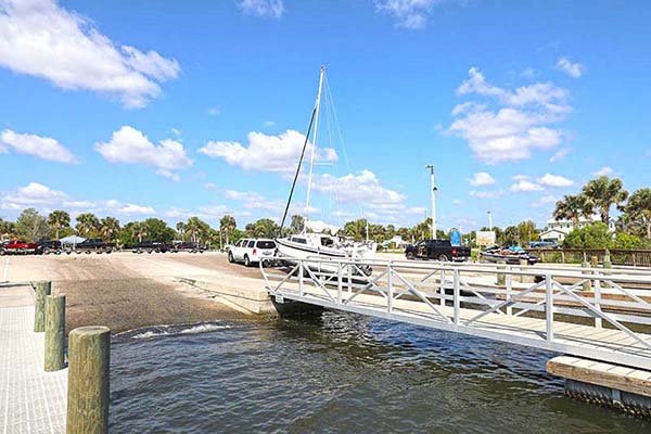 Trucking using ramp to put boat into river