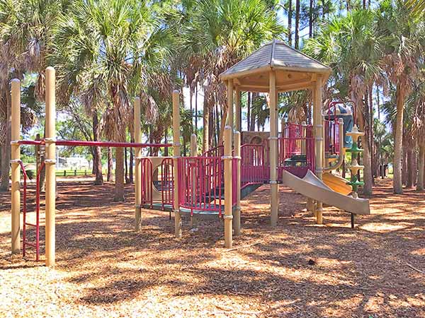 McKnight Family Sports Complex Playground Playground area surrounded by trees