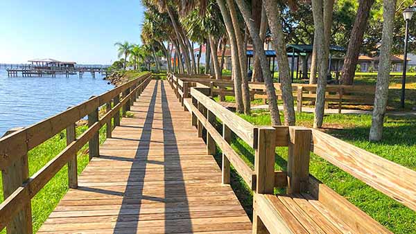 Boardwalk along water leading to pavilions