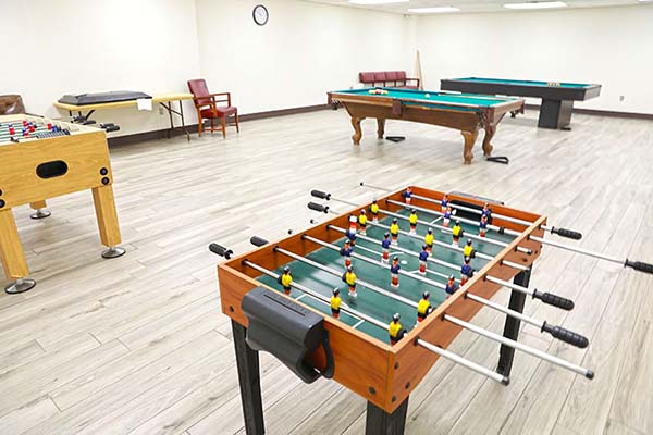 Foosball and pool tables in game room Foosball and pool tables in game room