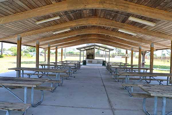 Picnic tables inside large pavilion Picnic tables inside large pavilion