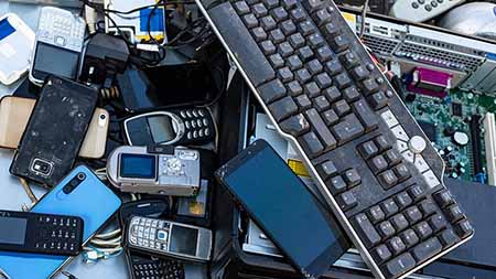 Pile of used phones and computer parts.