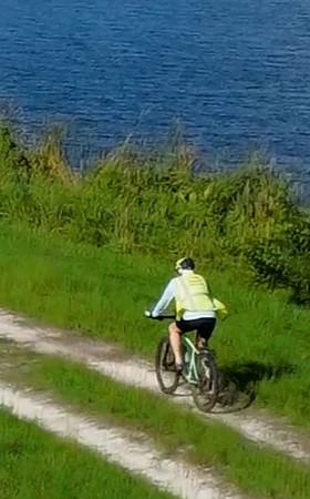 Person riding a bicycle at the Viera Wetlands. Person riding a bicycle at the Viera Wetlands.